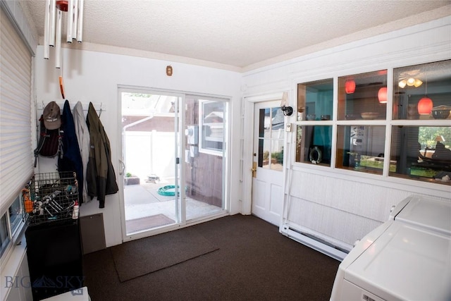 706 Locust St, Anaconda, MT 59711 - entryway featuring a baseboard heating unit, a textured ceiling, dark carpet, and separate washer and dryer