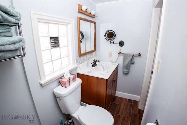 706 Locust St, Anaconda, MT 59711 - bathroom with wood finished floors, vanity, and ornamental molding