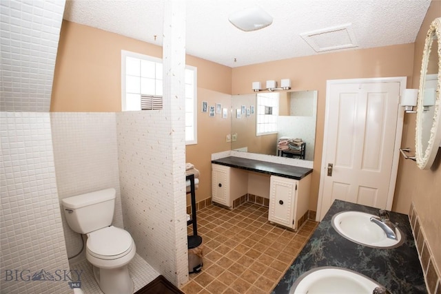 706 Locust St, Anaconda, MT 59711 - bathroom with double vanity and a textured ceiling