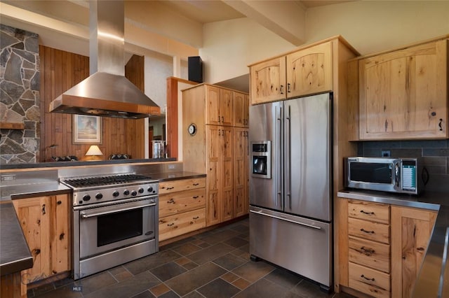 1520 Black Bull Trl, Bozeman, MT 59718 - kitchen with high quality appliances, wall chimney range hood, light brown cabinetry, stainless steel countertops, and decorative backsplash