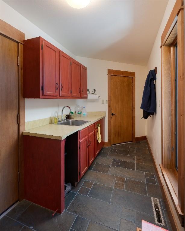 1520 Black Bull Trl, Bozeman, MT 59718 - kitchen with light countertops and stone tile flooring