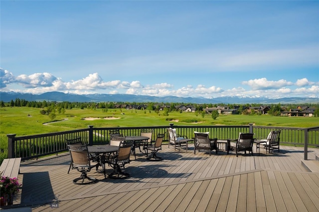 1520 Black Bull Trl, Bozeman, MT 59718 - wooden deck with a mountain view, outdoor dining space, view of golf course, and a yard