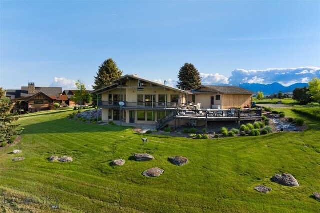 1520 Black Bull Trl, Bozeman, MT 59718 - back of house with a lawn, stairs, and a deck