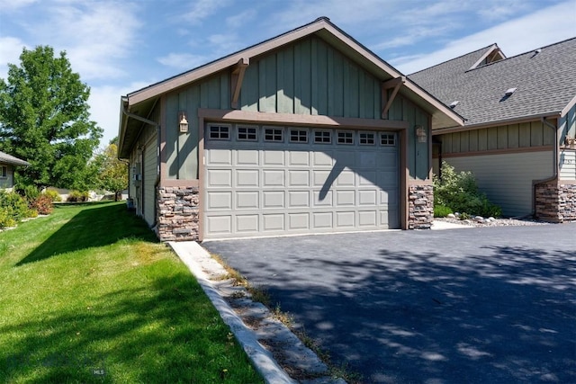 2757 Marlyn Ct Unit 1, Bozeman, MT 59718 - view of front of home featuring stone siding, board and batten siding, a front lawn, and roof with shingles