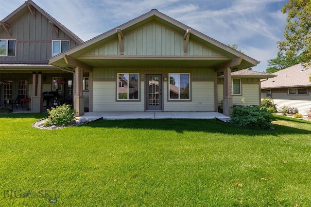 2757 Marlyn Ct Unit 1, Bozeman, MT 59718 - back of property featuring board and batten siding, a yard, and a patio