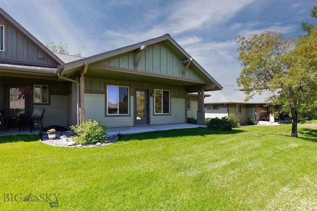 2757 Marlyn Ct Unit 1, Bozeman, MT 59718 - rear view of property featuring board and batten siding, a yard, and a patio