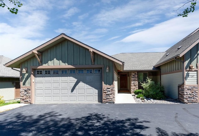 2757 Marlyn Ct Unit 1, Bozeman, MT 59718 - view of front of property with board and batten siding, stone siding, a garage, and asphalt driveway