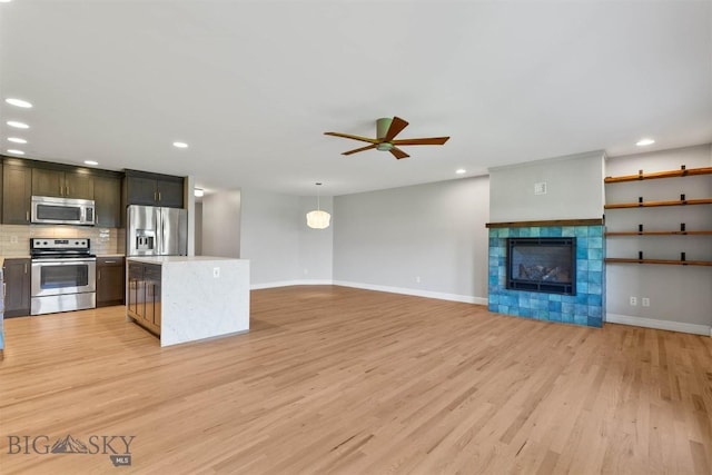 2757 Marlyn Ct Unit 1, Bozeman, MT 59718 - kitchen featuring stainless steel appliances, light countertops, light wood-type flooring, a ceiling fan, and recessed lighting