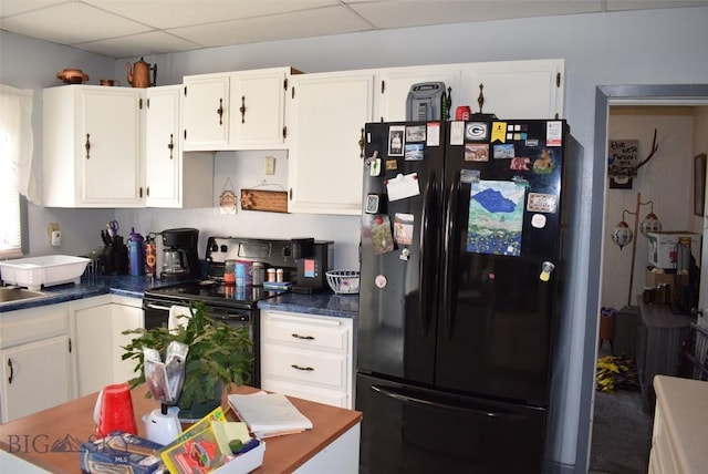 2200 Elm, Butte, MT 59701 - kitchen with black appliances, white cabinetry, a paneled ceiling, and dark countertops