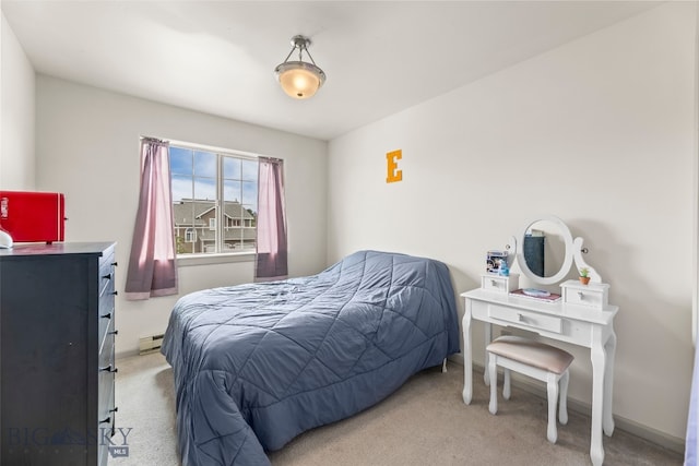 1110 Biehl Unit C, Belgrade, MT 59714 - bedroom with light colored carpet and a baseboard radiator