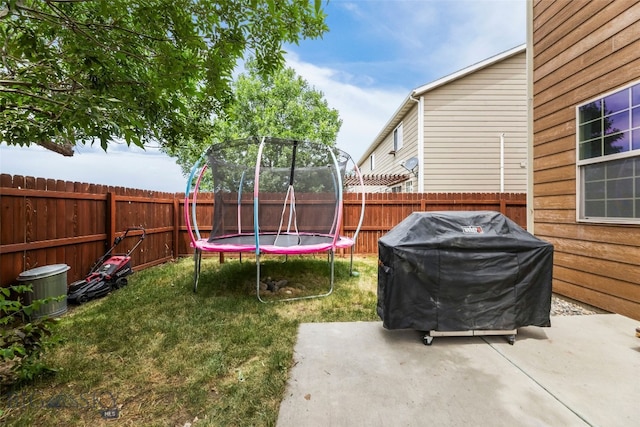 1110 Biehl Unit C, Belgrade, MT 59714 - fenced backyard featuring a trampoline and a patio area
