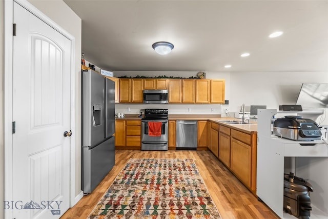 1110 Biehl Unit C, Belgrade, MT 59714 - kitchen with stainless steel appliances, light wood-type flooring, light countertops, and recessed lighting