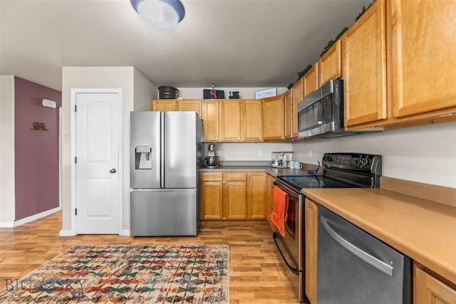 1110 Biehl Unit C, Belgrade, MT 59714 - kitchen with appliances with stainless steel finishes and light wood finished floors