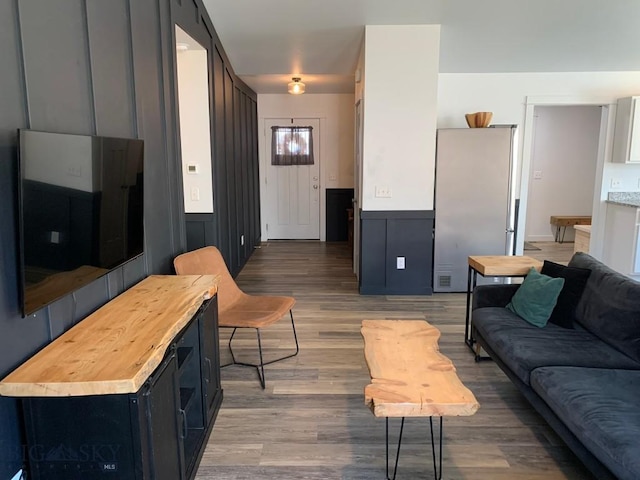 801 Pleiades Pl, Livingston, MT 59047 - living room featuring light wood-style flooring, a decorative wall, and wainscoting