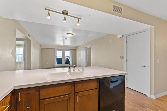 210 S Cottonwood Rd Unit 308, Bozeman, MT 59718 - kitchen with dishwasher, brown cabinets, light wood-type flooring, light countertops, and open floor plan