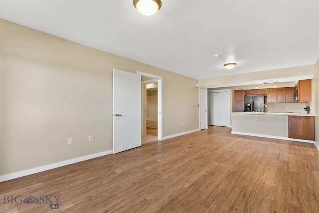 210 S Cottonwood Rd Unit 308, Bozeman, MT 59718 - unfurnished living room featuring light wood finished floors