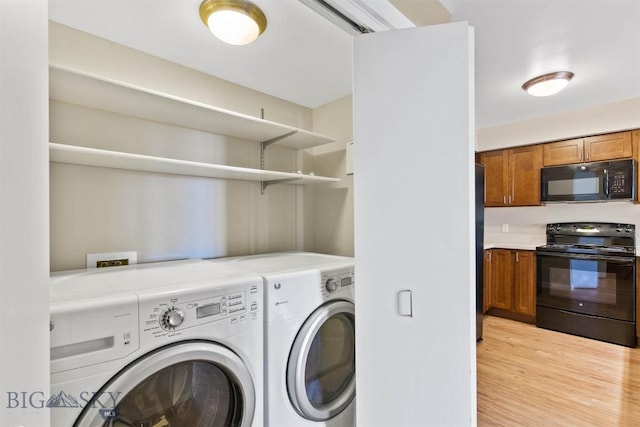 210 S Cottonwood Rd Unit 308, Bozeman, MT 59718 - washroom featuring washing machine and clothes dryer and light wood-style flooring