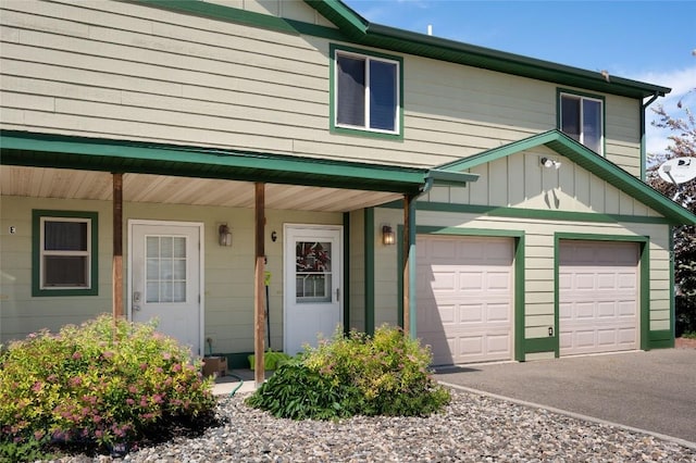 1132 Cruiser Ln Unit F, Belgrade, MT 59714 - multi unit property featuring asphalt driveway, covered porch, and board and batten siding