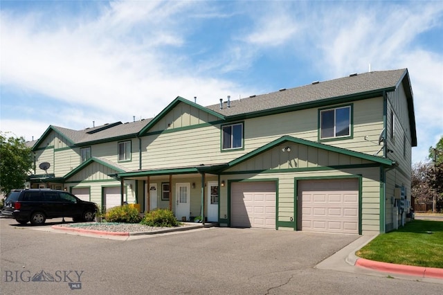 1132 Cruiser Ln Unit F, Belgrade, MT 59714 - view of property featuring board and batten siding, asphalt driveway, and an attached garage