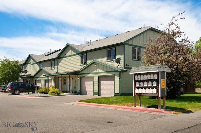 1132 Cruiser Ln Unit F, Belgrade, MT 59714 - multi unit property with board and batten siding, concrete driveway, and a front lawn