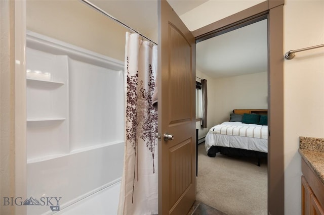 1132 Cruiser Ln Unit F, Belgrade, MT 59714 - ensuite bathroom featuring vanity, a shower with curtain, and a baseboard radiator