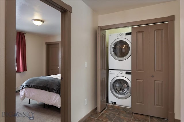 1132 Cruiser Ln Unit F, Belgrade, MT 59714 - laundry room featuring stacked washer and clothes dryer and baseboard heating