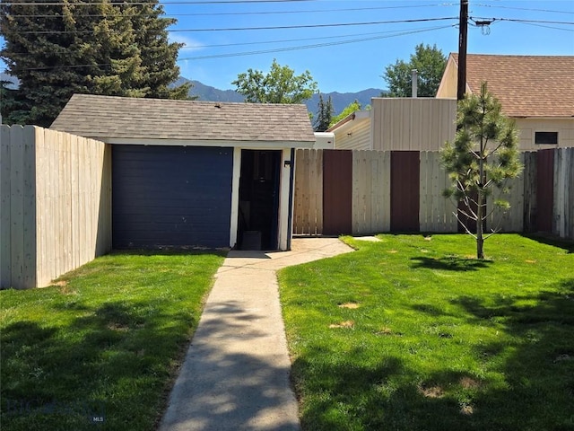 1906 Thomas Ave, Butte, MT 59701 - view of front of house with a shed, a mountain view, a fenced backyard, and a shingled roof
