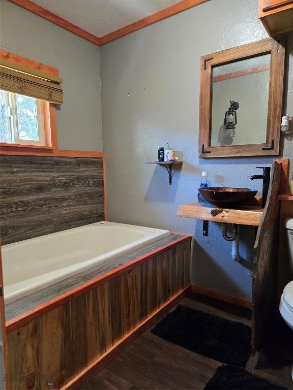 1906 Thomas Ave, Butte, MT 59701 - full bath with wood finished floors, a bathtub, and ornamental molding