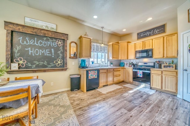 215 N 4th St Unit B, Manhattan, MT 59741 - kitchen with black appliances, light brown cabinetry, light wood-type flooring, backsplash, and light countertops