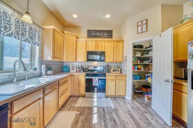 215 N 4th St Unit B, Manhattan, MT 59741 - kitchen with stainless steel gas range, black microwave, light brown cabinets, light wood-style flooring, and recessed lighting