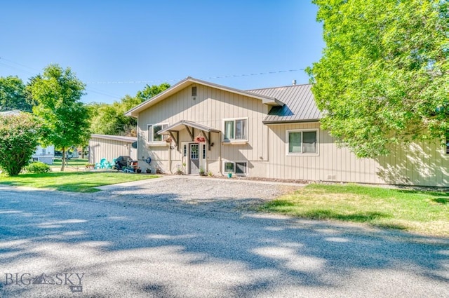 215 N 4th St Unit B, Manhattan, MT 59741 - view of front of home featuring a standing seam roof, a metal roof, driveway, and a front lawn