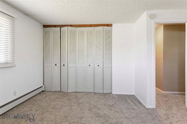 34 Mammoth Dr, Butte, MT 59701 - unfurnished bedroom with a baseboard radiator, carpet flooring, a textured ceiling, and a closet
