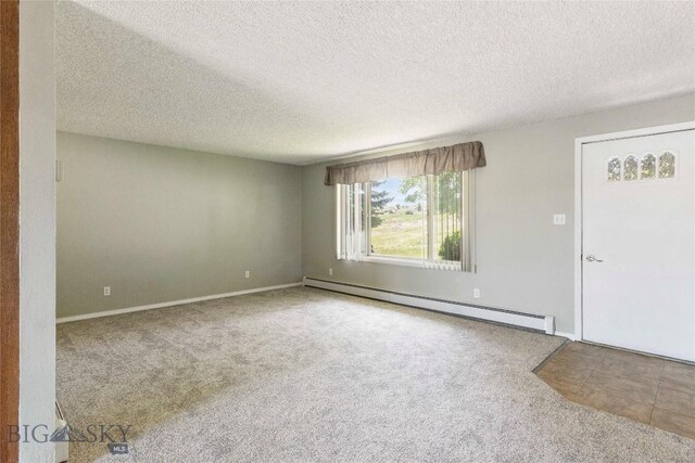 34 Mammoth Dr, Butte, MT 59701 - carpeted empty room featuring a baseboard radiator and a textured ceiling