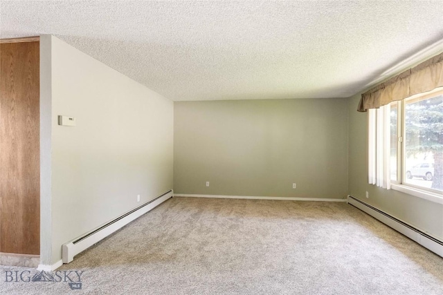 34 Mammoth Dr, Butte, MT 59701 - spare room with a baseboard heating unit, a textured ceiling, and light colored carpet