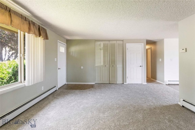 34 Mammoth Dr, Butte, MT 59701 - carpeted spare room with a baseboard heating unit and a textured ceiling