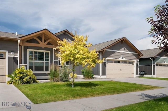 5479 Annie St, Bozeman, MT 59718 - view of front of house featuring an attached garage, a front yard, and driveway