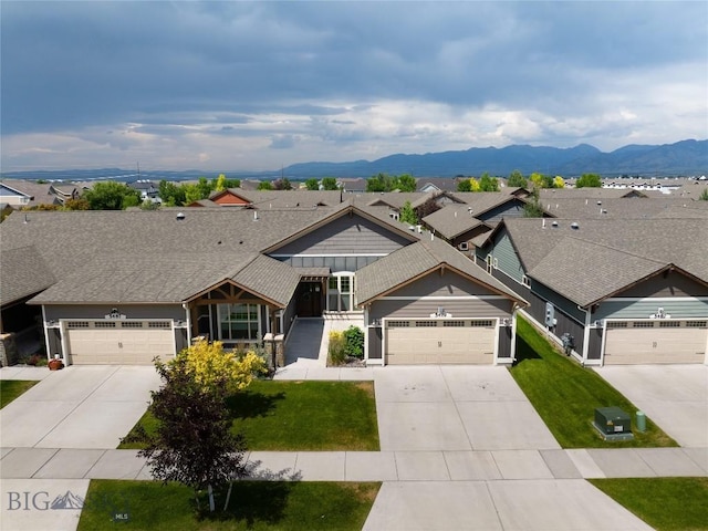 5479 Annie St, Bozeman, MT 59718 - view of front of house featuring concrete driveway, roof with shingles, a front yard, and a garage