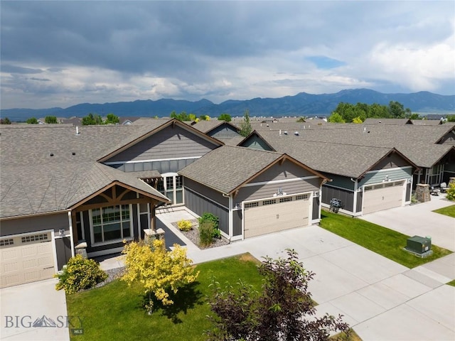 5479 Annie St, Bozeman, MT 59718 - view of front of home with an attached garage, driveway, a front lawn, a mountain view, and roof with shingles