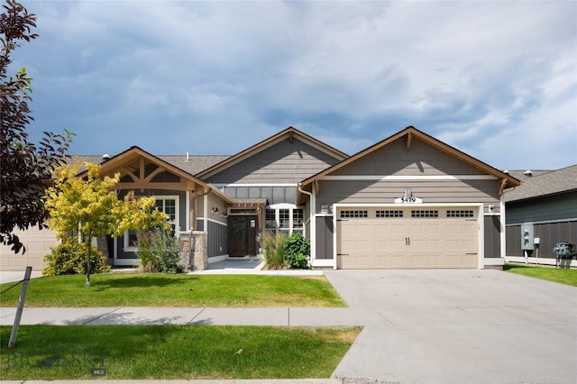 5479 Annie St, Bozeman, MT 59718 - view of front of property with an attached garage, a front yard, and concrete driveway