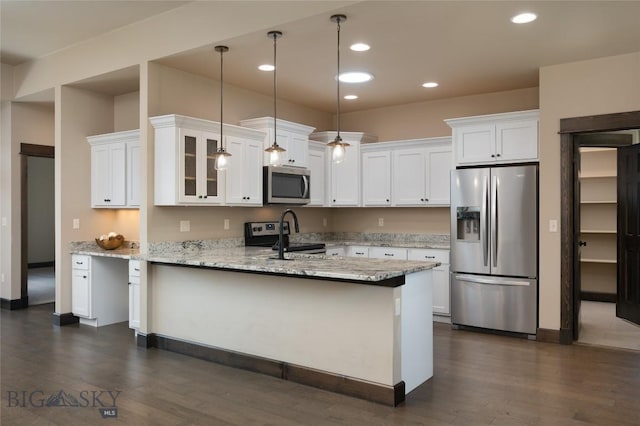 5479 Annie St, Bozeman, MT 59718 - kitchen featuring stainless steel appliances, a peninsula, dark wood-style flooring, white cabinetry, and recessed lighting