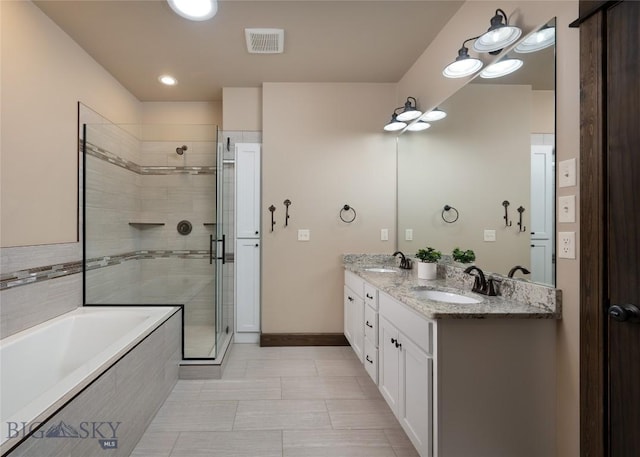 5479 Annie St, Bozeman, MT 59718 - full bathroom with a bath, a stall shower, double vanity, and tile patterned flooring