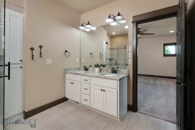 5479 Annie St, Bozeman, MT 59718 - bathroom featuring double vanity, a shower stall, and a ceiling fan