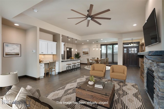 5479 Annie St, Bozeman, MT 59718 - living area featuring dark wood finished floors, ceiling fan, a fireplace, and recessed lighting