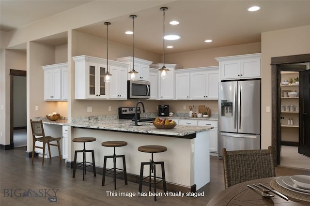 5479 Annie St, Bozeman, MT 59718 - kitchen featuring stainless steel appliances, a peninsula, white cabinets, glass insert cabinets, and dark wood-type flooring