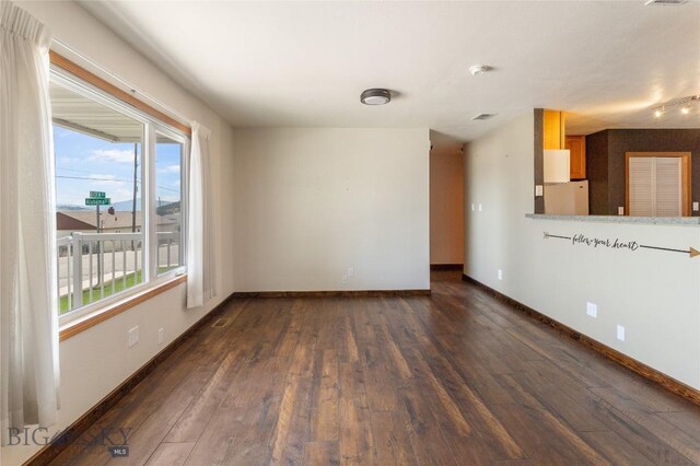 735 10th St, Butte, MT 59701 - unfurnished living room with dark wood-style floors