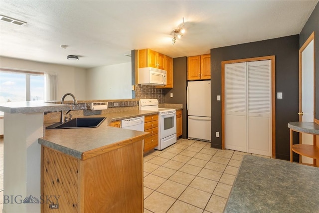 735 10th St, Butte, MT 59701 - kitchen with white appliances, a peninsula, light tile patterned floors, and backsplash