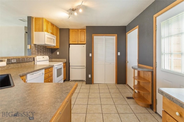 735 10th St, Butte, MT 59701 - kitchen featuring white appliances, decorative backsplash, and light tile patterned floors