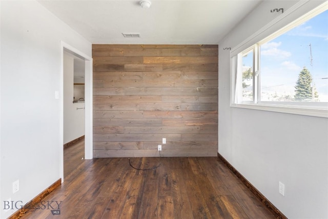 735 10th St, Butte, MT 59701 - unfurnished room featuring wood walls, wood finished floors, and a smoke detector