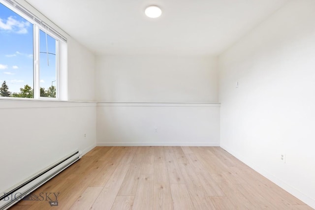 1714 S 19th Ave, Bozeman, MT 59718 - empty room featuring a baseboard heating unit and light wood-style flooring