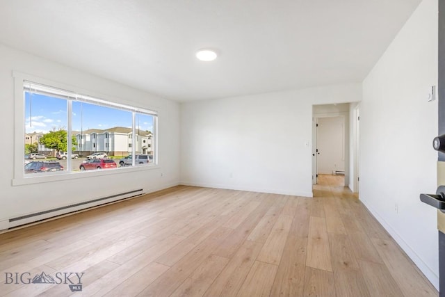 1714 S 19th Ave, Bozeman, MT 59718 - spare room with light wood-style floors and a baseboard radiator